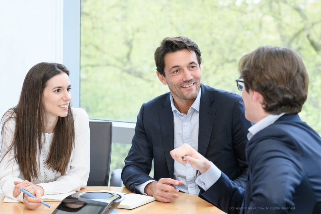 a trio of professionals, immersed in a meaningful exchange of ideas